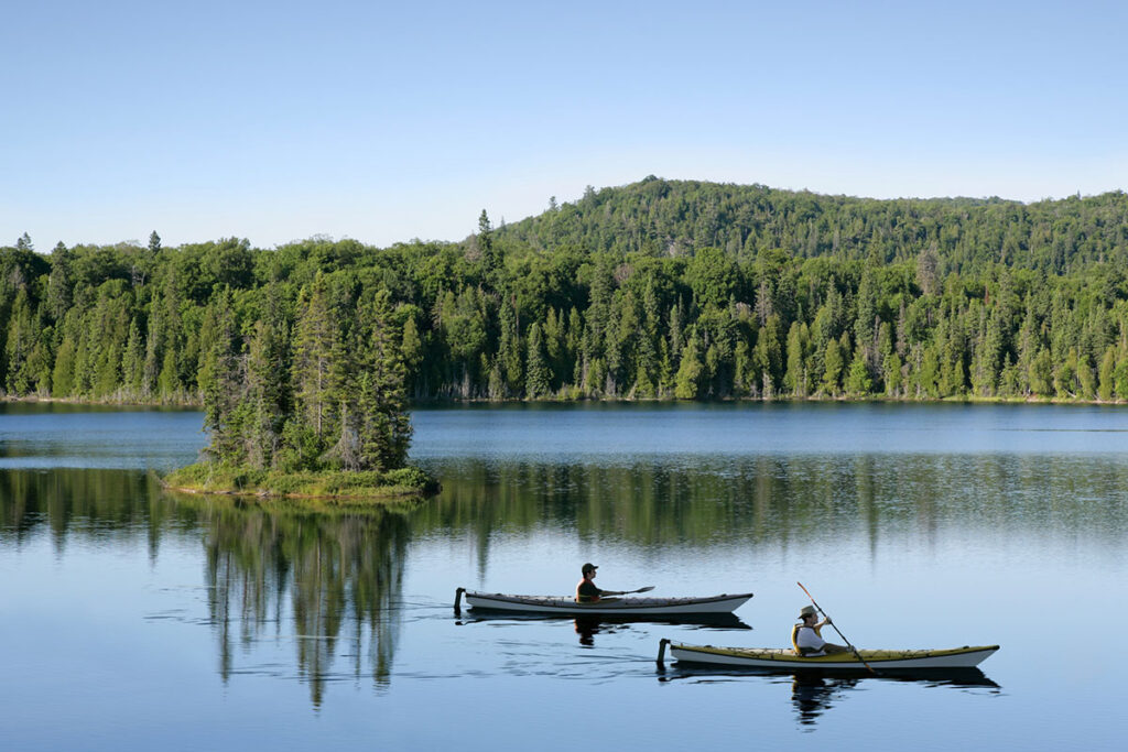 people kayaking on a serene lake