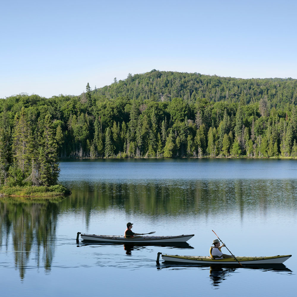 people kayaking on a serene lake