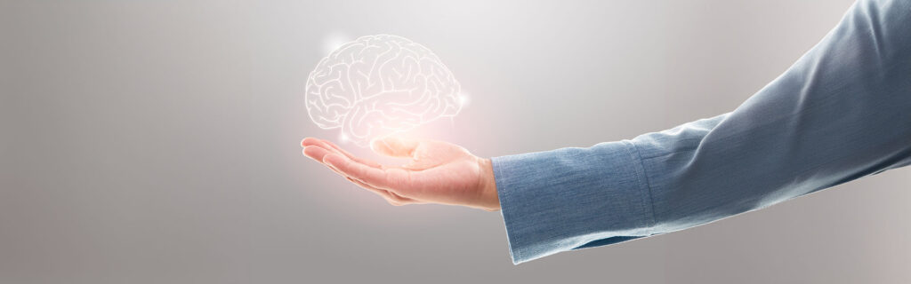 brain made of light hovering in a persons hand