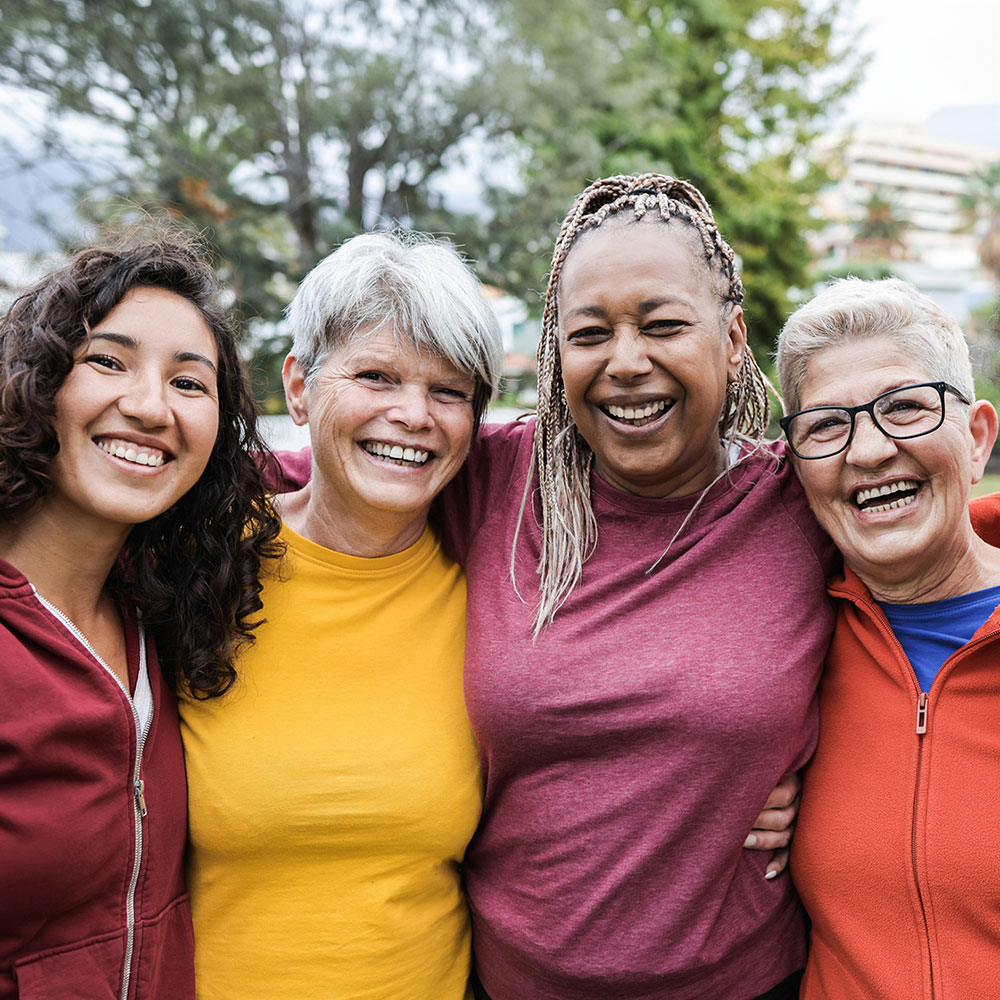 group of multi ethnic women smiling and looking at the camera